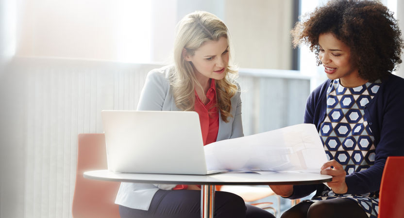 Two employees reviewing documents